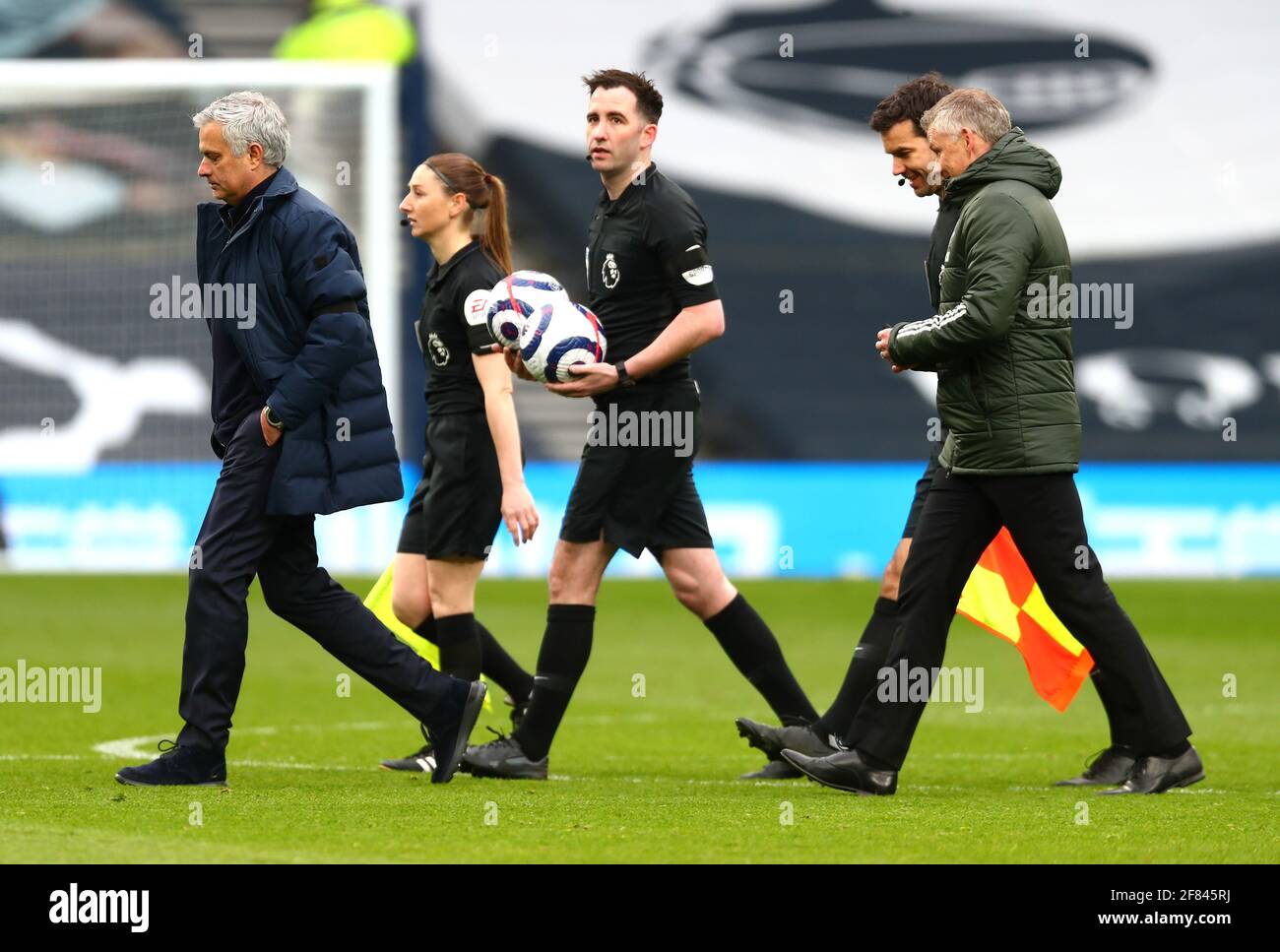 Tottenham Hotspur manager Jose Mourinho (left) and Manchester United manager Ole Gunnar Solskjaer (right) walk with match officials after the final whistle during the Premier League match at the Tottenham Hotspur Stadium, London. Picture date: Sunday April 11, 2021. Stock Photo