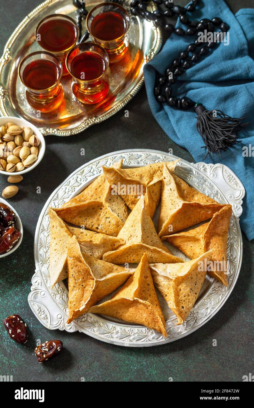 Arabic Cuisine. Ramadan Kareem Festive. Ramadan menu, arabian pancake katayef (katayev, qatayef) and dates, pistachio. Stock Photo