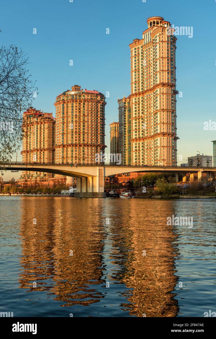 Moscow tall buildings at Moskva River, Russia. Residential complex Alye Parusa on blue sky. Vertical view of Stroginsky Bridge and skyscrapers in Mosc Stock Photo