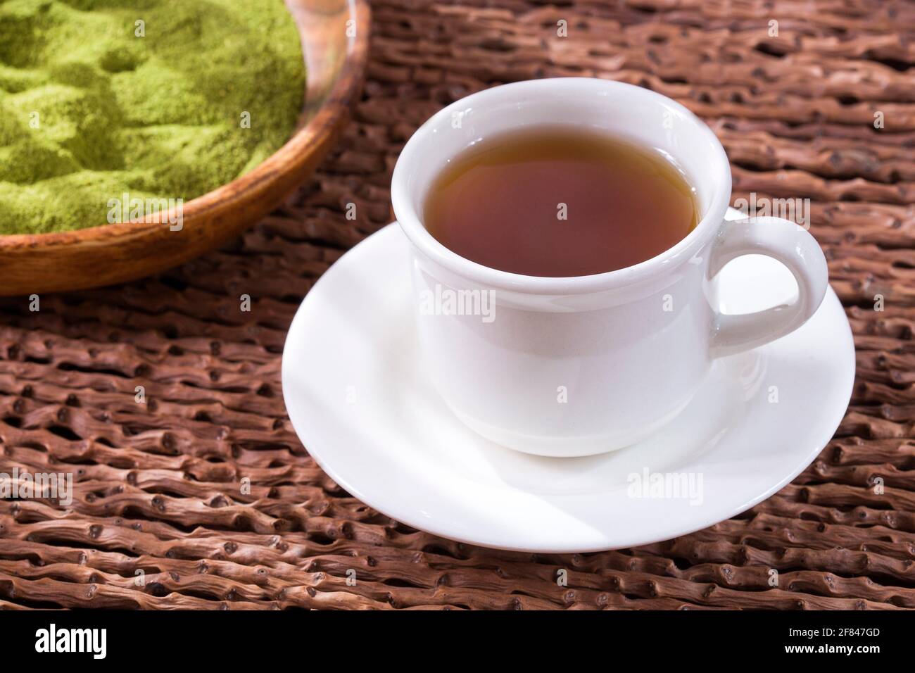 Moringa tea with powder and leaves - Moringa oleifera. Wooden ...