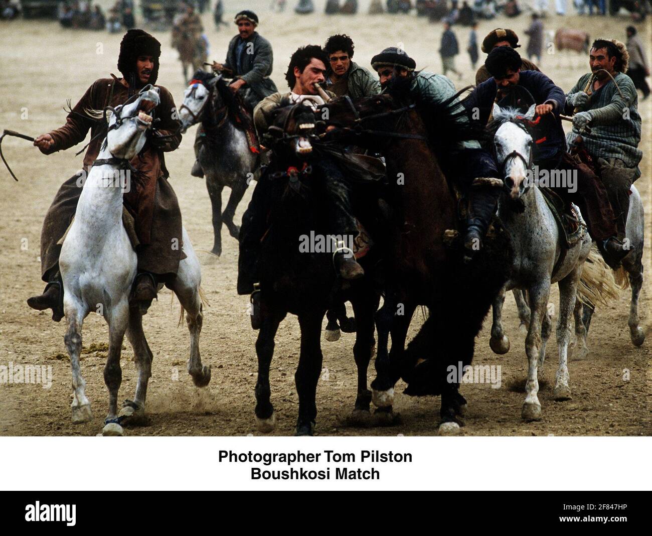 Buzkashi Match in the killing fields, were Afghan who are fighting for a headless calf used to play Buzkashi, to win thwe game the carcass must be carried around a flag and dumped in the centre of the circle. Stock Photo