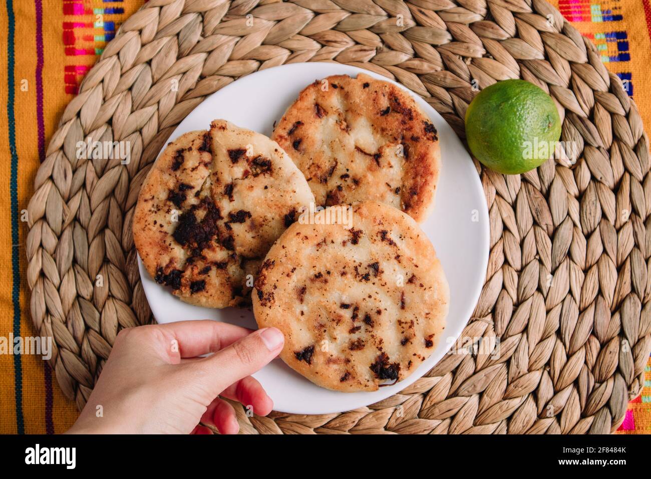 Hand picking gordita de chicharrón prensado, traditional mexican food Stock Photo