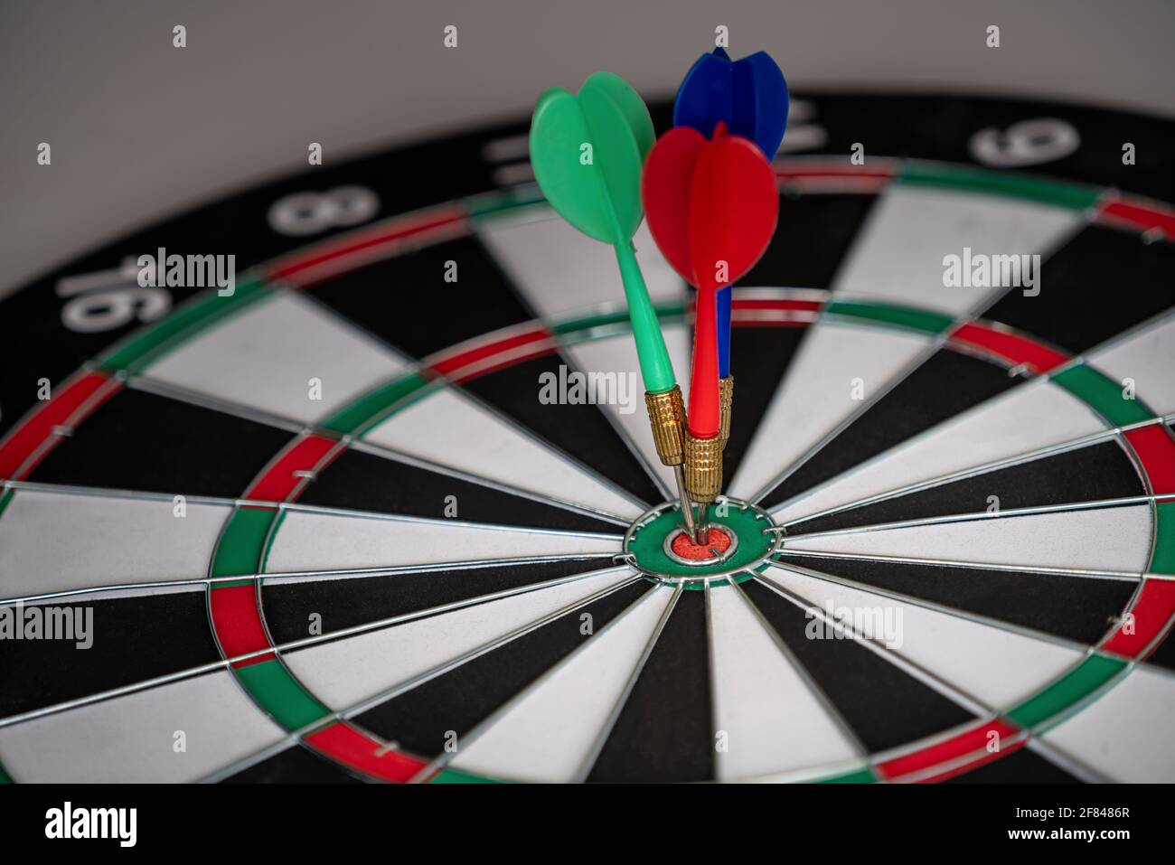Concept of challenge in business marketing bullseye and intelligent customer reaching. The dart is the strategy or skill. The dartboard is the target Stock Photo