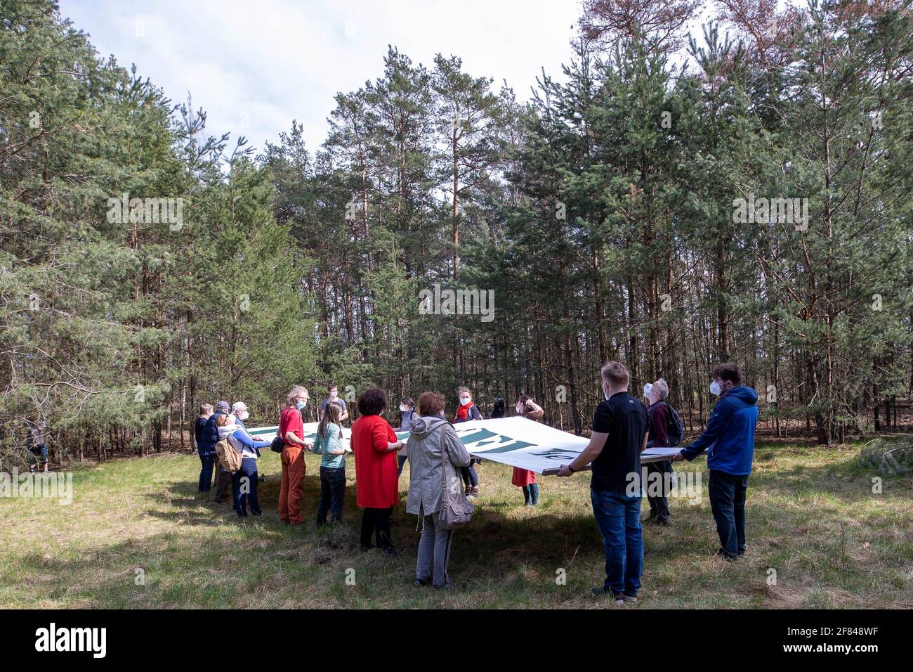 Schleife, Germany. 11th Apr, 2021. A banner with the inscription 'UNVERKÄUFLICH www.kein-tagebau.de' is set up in the forest near Schleife. The protest action 'Unverkäuflich' of the environmental network Grüne Liga in Schleife near the opencast mine Nochten in the district of Görlitz is directed against the threatening dredging by LEAG (Lausitz Energie Bergbau AG). Credit: Daniel Schäfer/dpa-Zentralbild/dpa/Alamy Live News Stock Photo