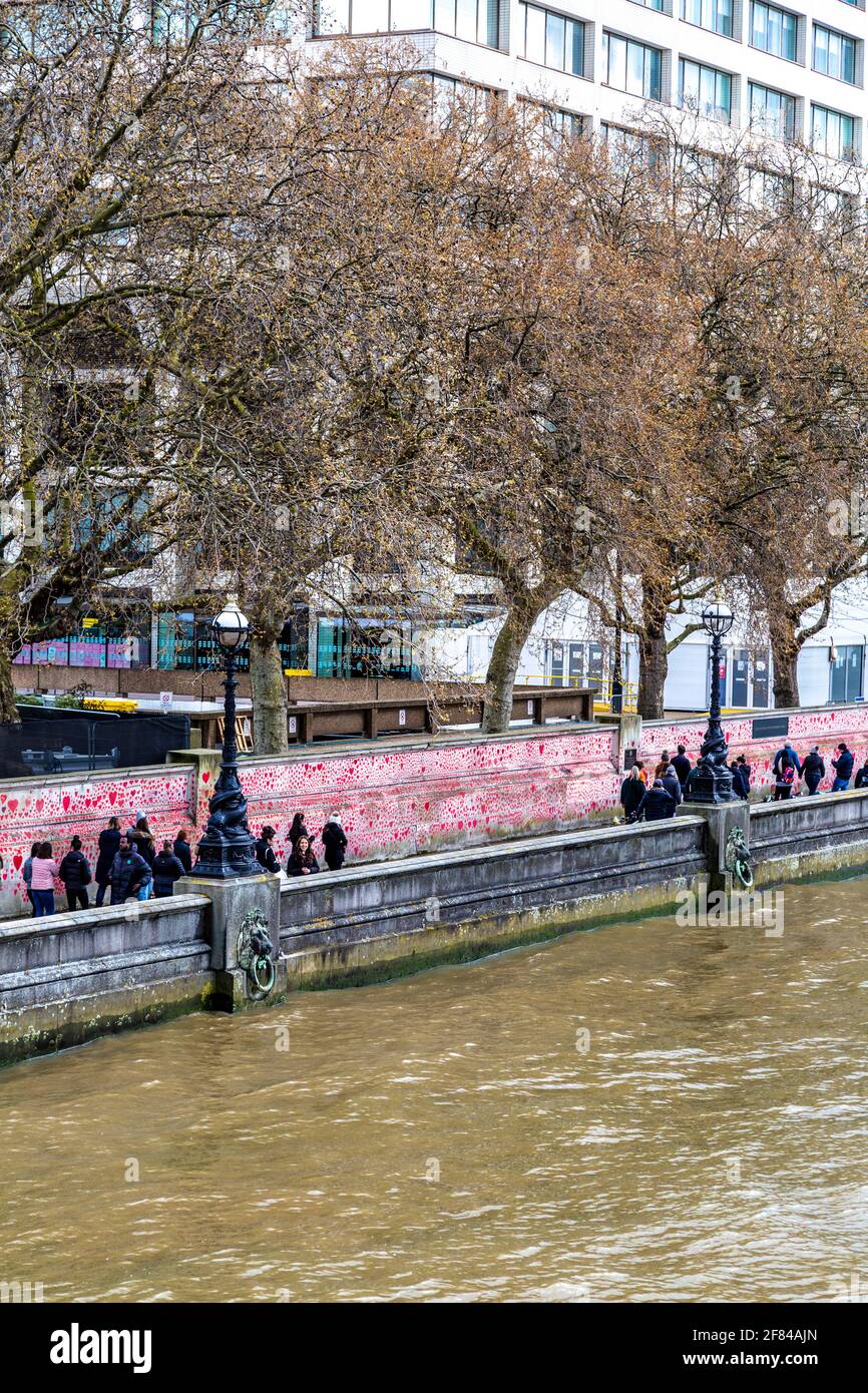 11 April 2021, London, UK - The National COVID Memorial Wall along the South Bank filled with hearts to commemorate those who died during the coronavirus pandemic Stock Photo