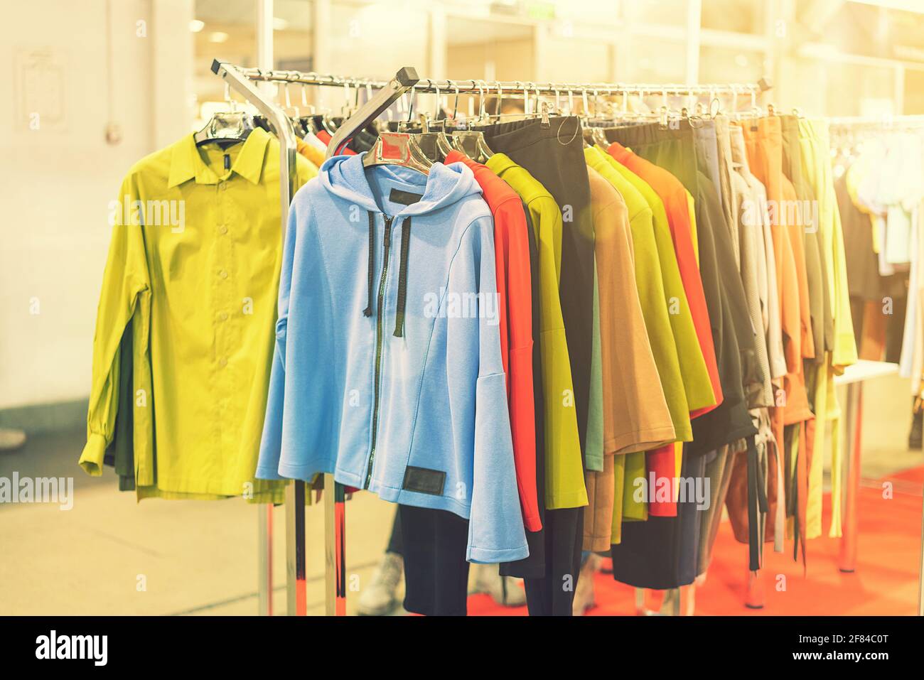 spring and summer women's clothing in the store. bright, modern clothes in a boutique. Women's hip clothing store interior concept. concept of choice Stock Photo