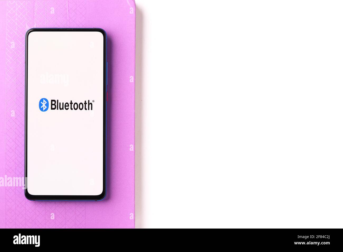 Assam, india - April 10, 2021 : Bluetooth logo on phone screen stock image. Stock Photo