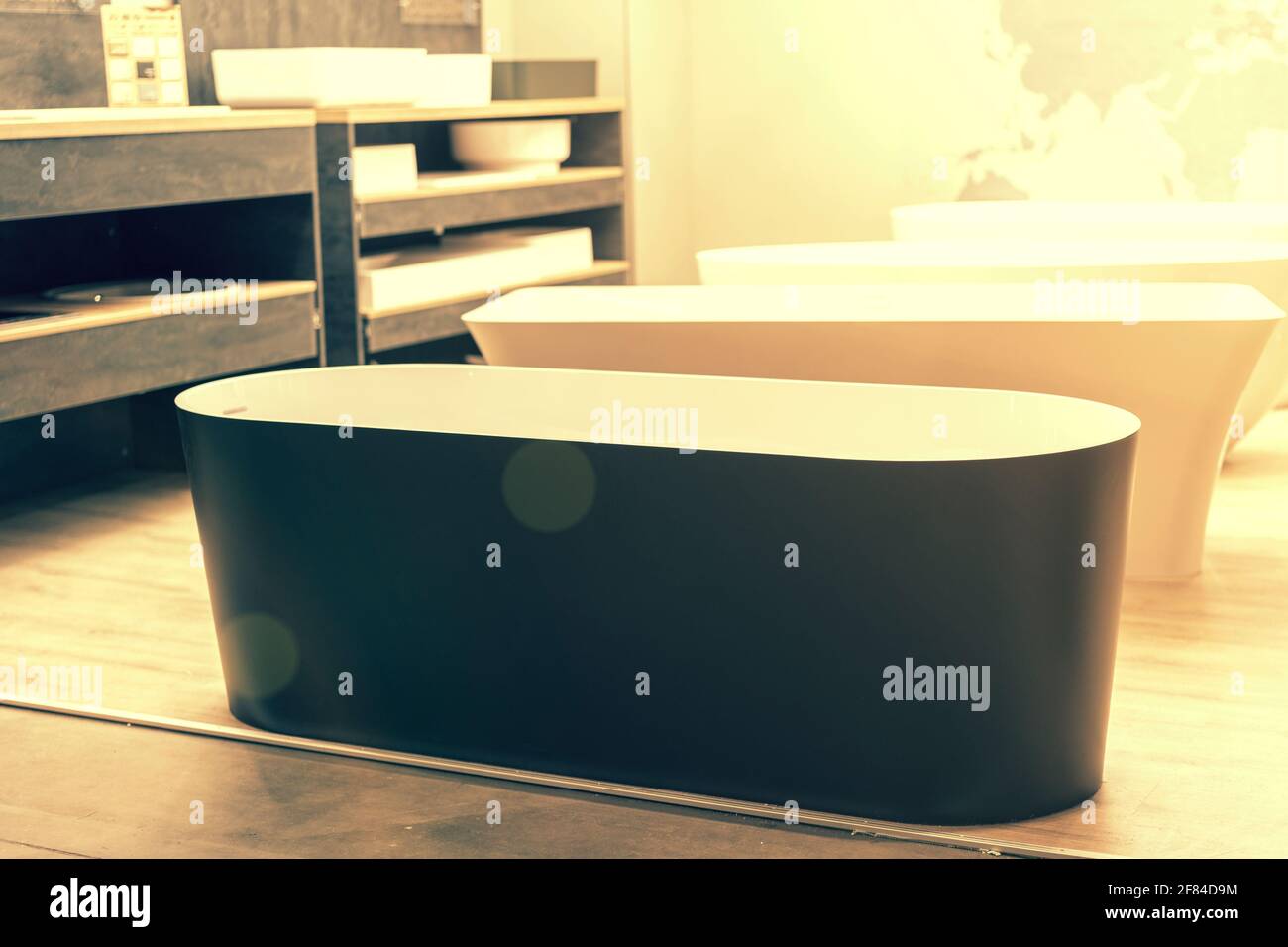 Black bathtub at a hardware store. Sanitary engineering shop. toned