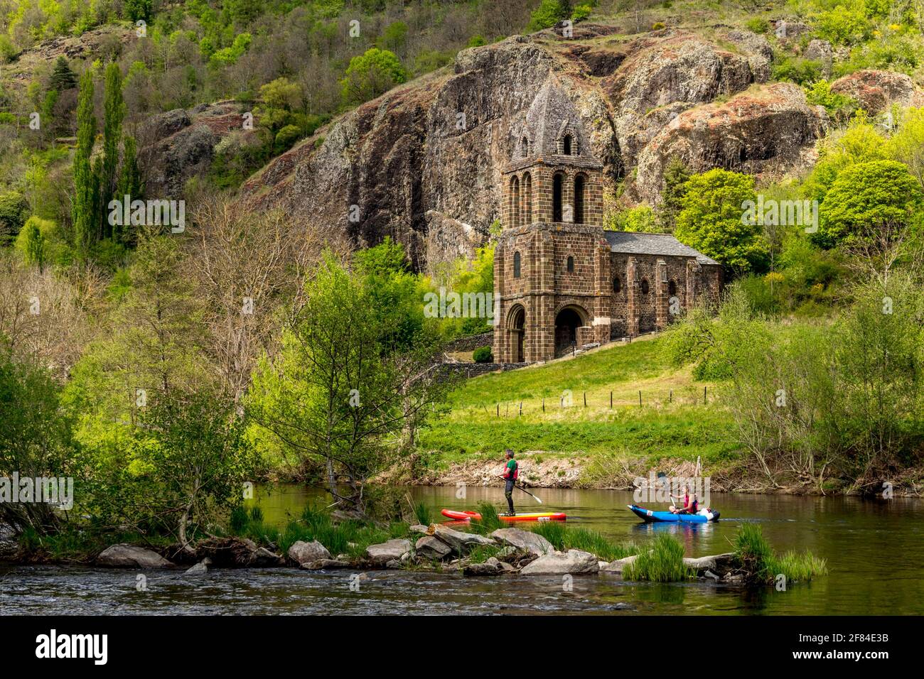 Notre Dame des Chazes church on the River Allier with canoeists, Haute Loire departement, Auvergne, France Stock Photo