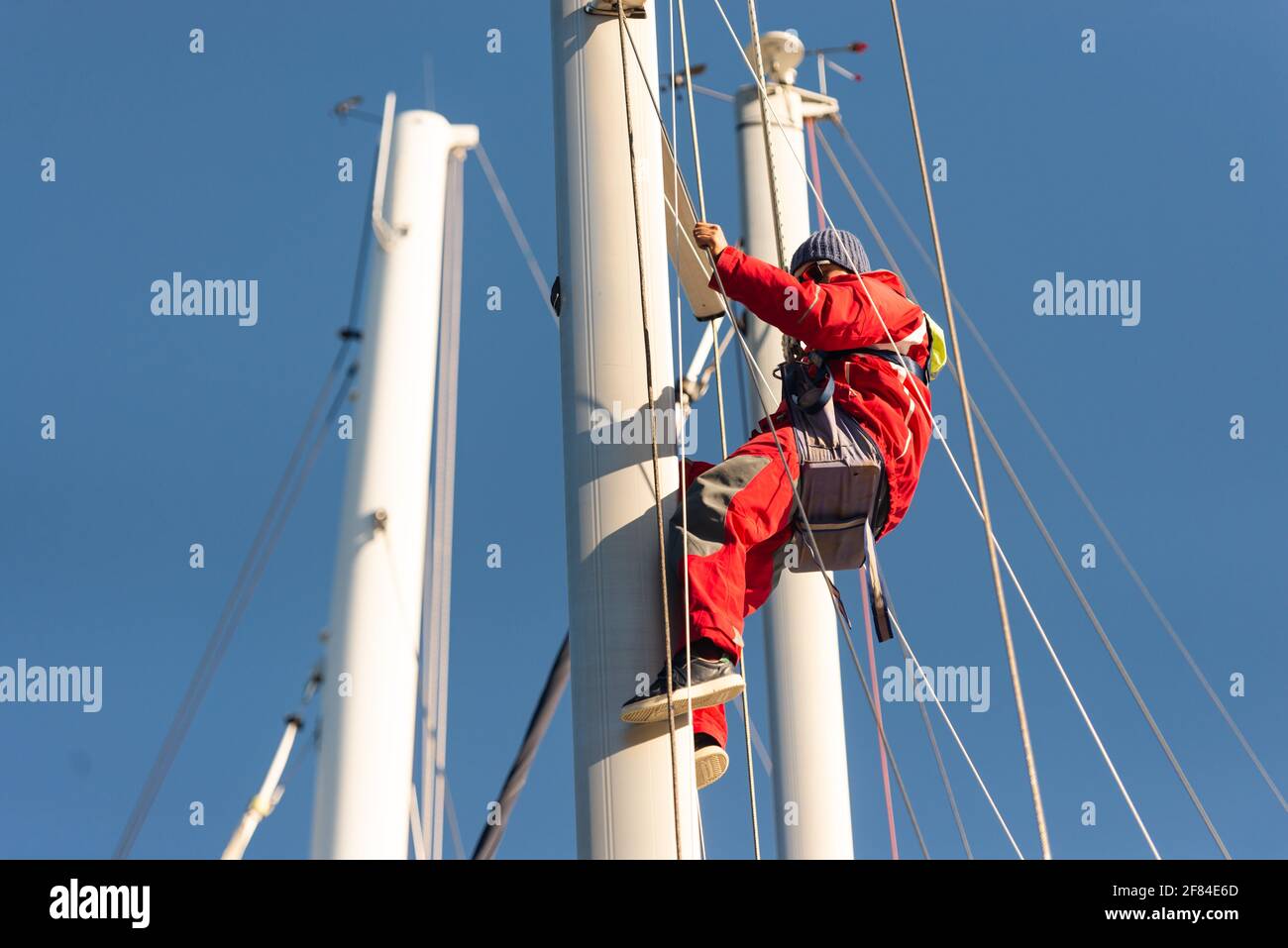 Sevastopol. Crimea. Autumn 2020. The yachtsman climbed the mast. Repair of the device for measuring wind speed and direction. Stock Photo