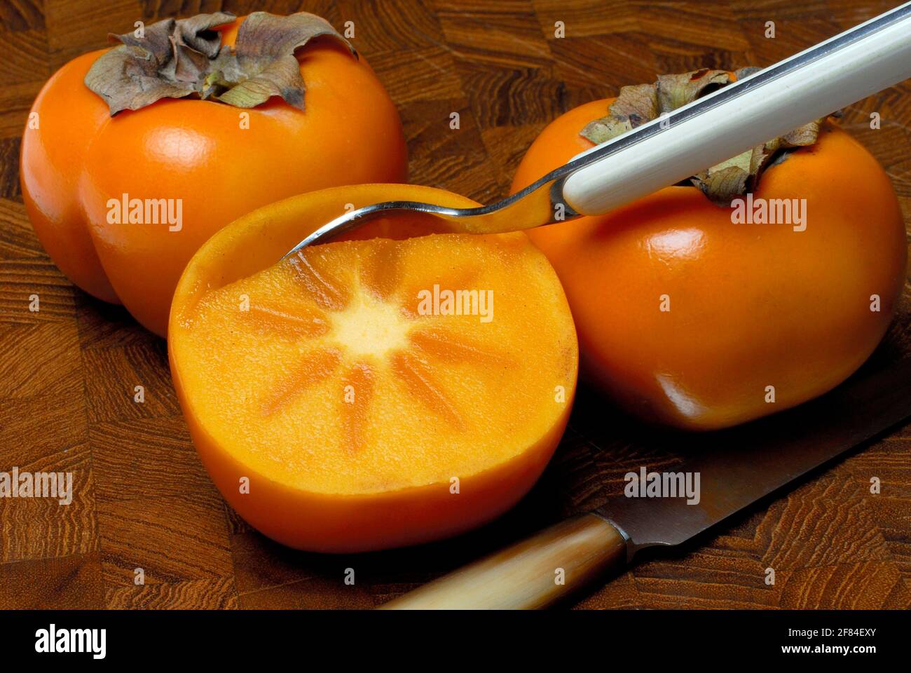 Persimmon, fruit, Japanese persimmon (Diospyros kaki) , (Ebenaceae) Spoon Stock Photo Alamy
