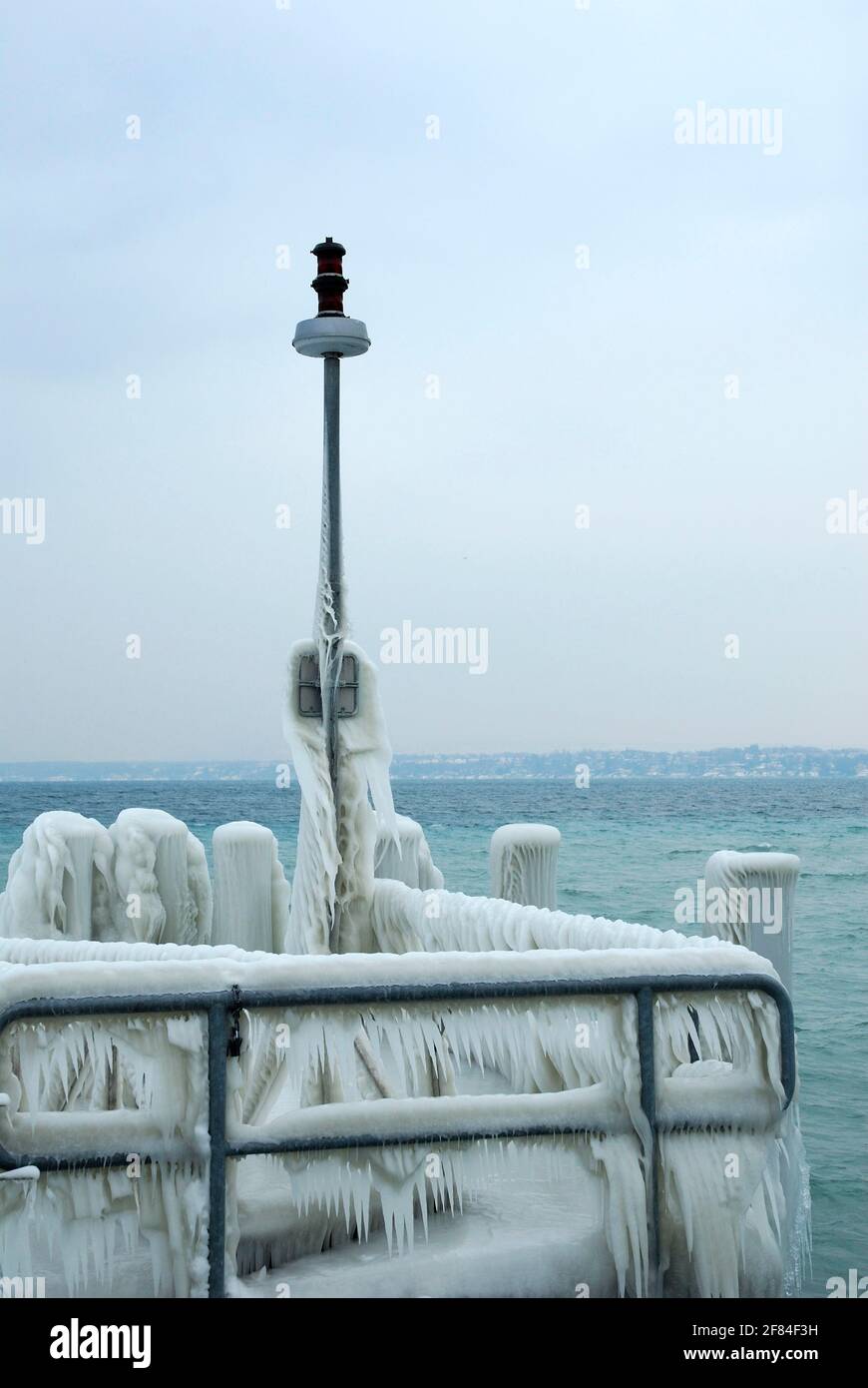 Railing of a ship station covered with ice, jetty, Lake Geneva, Versoix, Canton Geneva, Switzerland Stock Photo