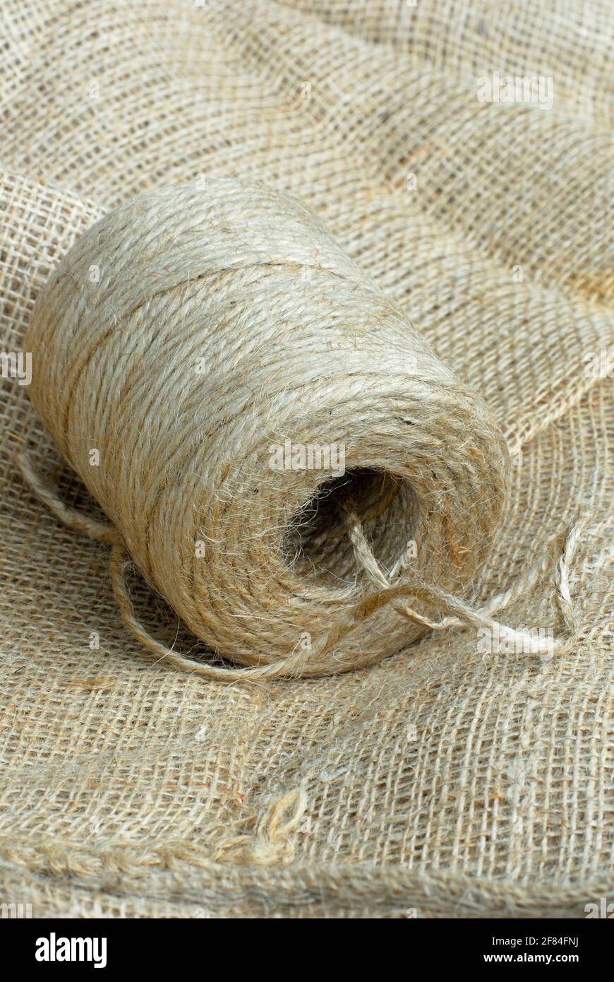 Roll of jute twine and jute fabric, jute thread, jute fibre, bast fibre, natural fibre, yarn, cord, vegetable fibre Stock Photo