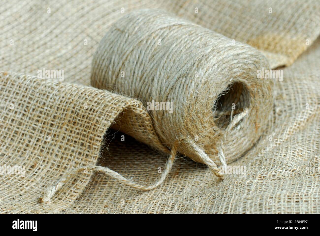 Roll of jute twine and jute fabric, jute thread, jute fibre, bast fibre, natural fibre, yarn, cord, vegetable fibre Stock Photo