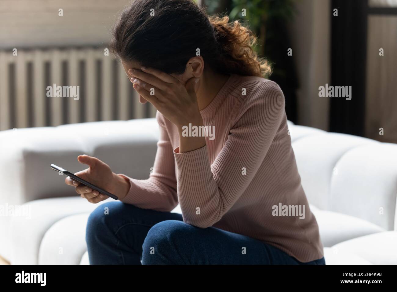 Stressed young latin lady get nasty blackmail message on email Stock Photo