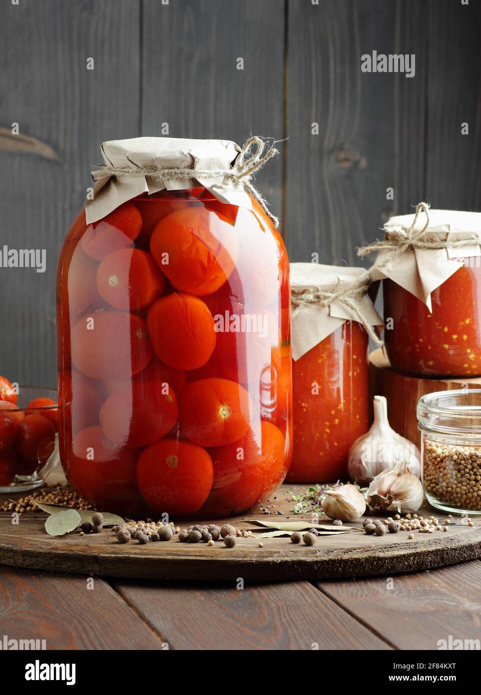 https://c8.alamy.com/comp/2F84KXT/canned-tomatoes-in-glass-jar-on-wooden-rustic-table-in-pantry-or-village-kitchen-closeup-cottagecore-simple-living-aesthetics-home-storage-solutio-2F84KXT.jpg