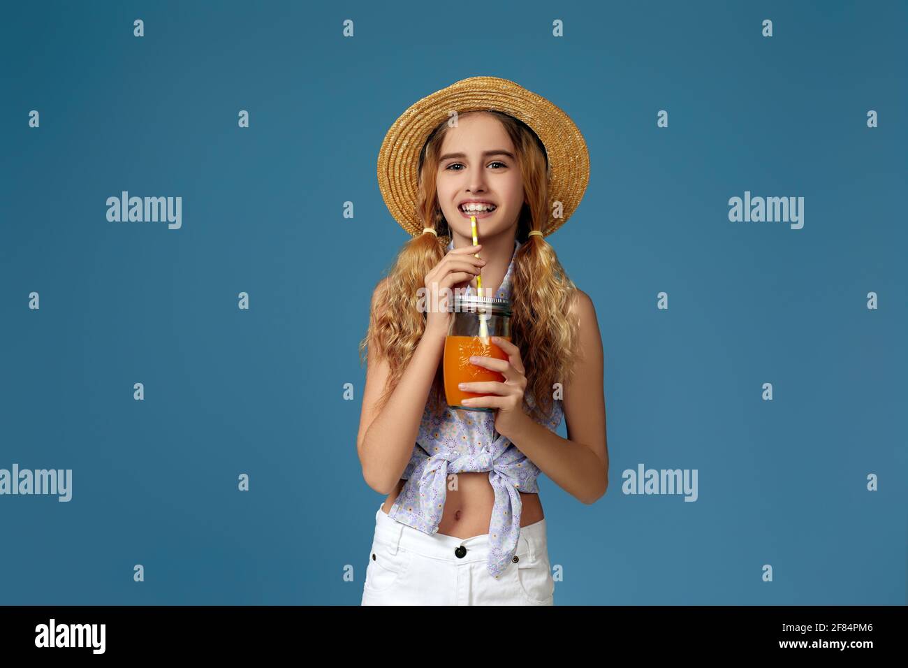 Portrait of cute little child girl drinking orange juice Stock Photo ...