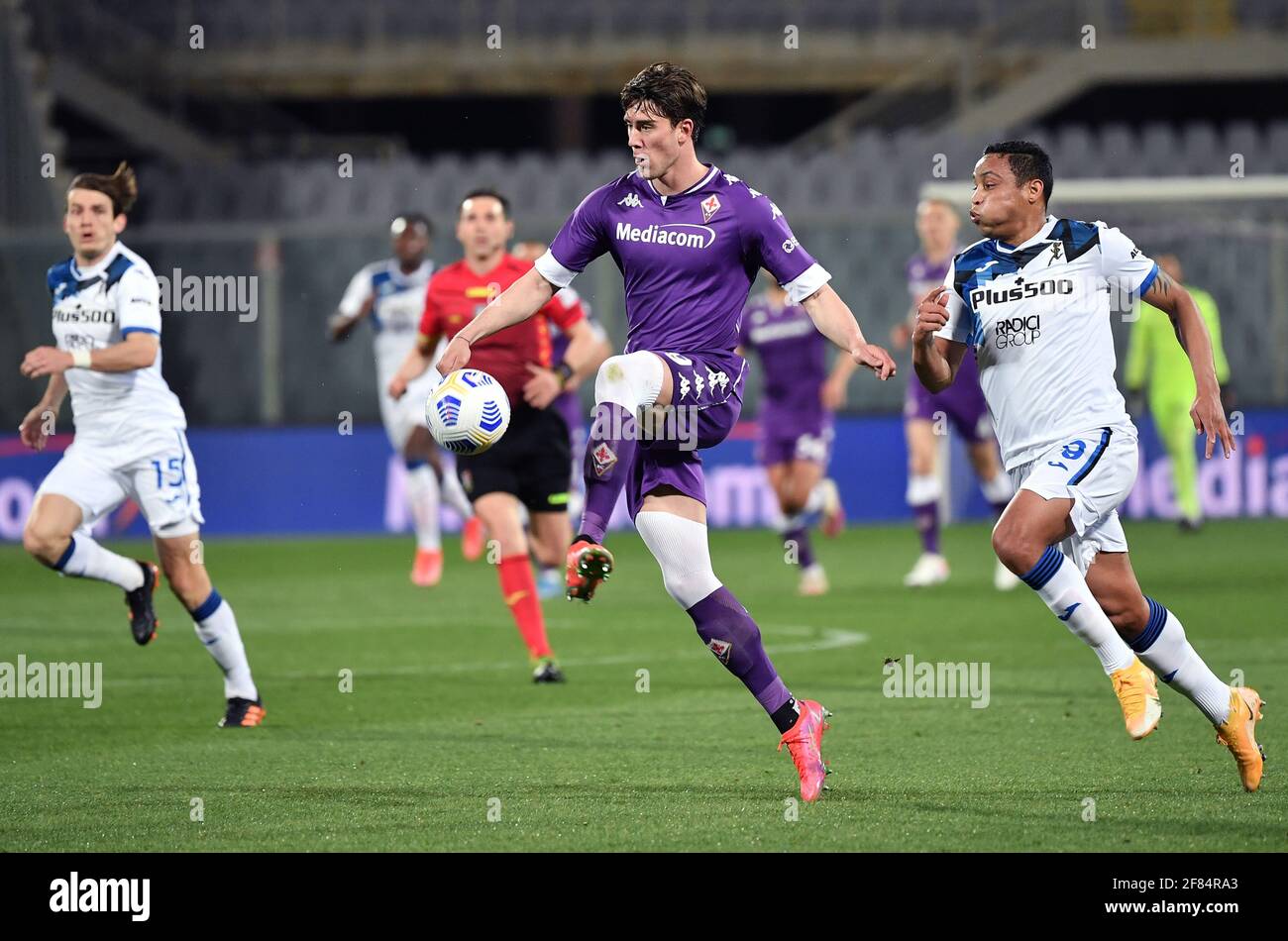 Florence, Italy. 11th Apr, 2021. Dusan Vlahovic of ACF Fiorentina and Luis  Muriel of Atalanta BC in action during the Serie A football match between  ACF Fiorentina and Atalanta Bergamasca Calcio at