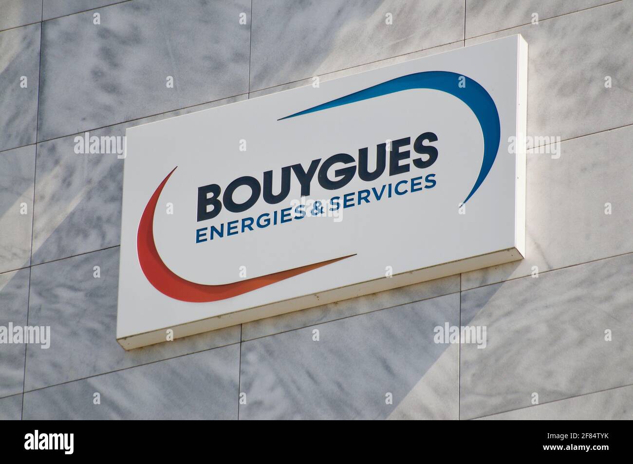 Zug, Switzerland - 28th March 2021 : Bouygues Energis & Services sign hanging on the office buliding in Zug, Switzerland. Bouygues energies and servic Stock Photo