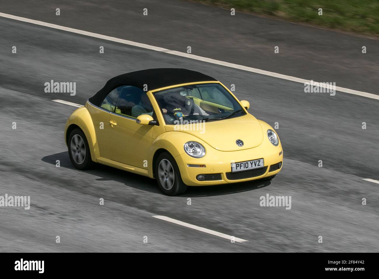 2010 Yellow VW Volkswagen Beetle Luna 102Ps 1596cc cabriolet driving on the M6 motorway near Preston in Lancashire, UK. Stock Photo