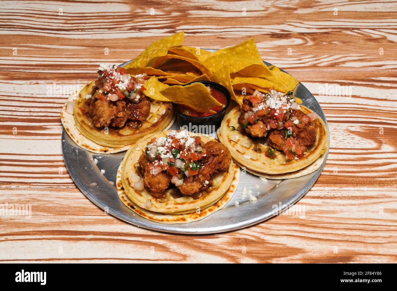 Delicious authentic dish known as chicken and waffle tacos Stock Photo