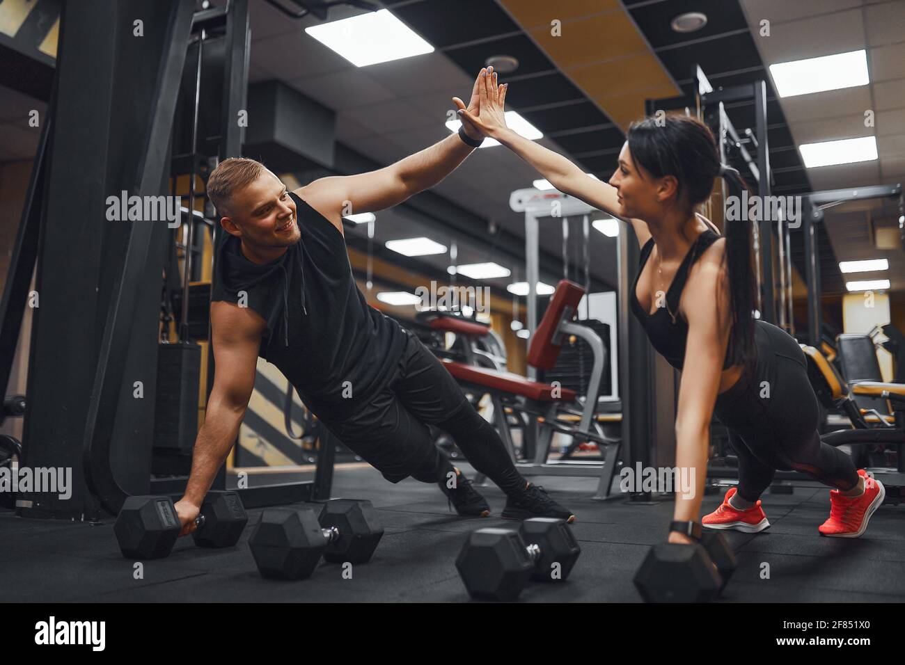 Strong and Beautiful Athletic Fitness Couple in Workout Clothes Doing Push  Up Exercises and Giving Each Other a High Five Stock Photo - Alamy