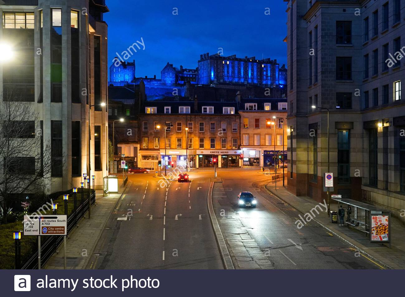 Edinburgh, Scotland, UK. 11th Apr 2021. Edinburgh Castle lit up in blue seen from the Western