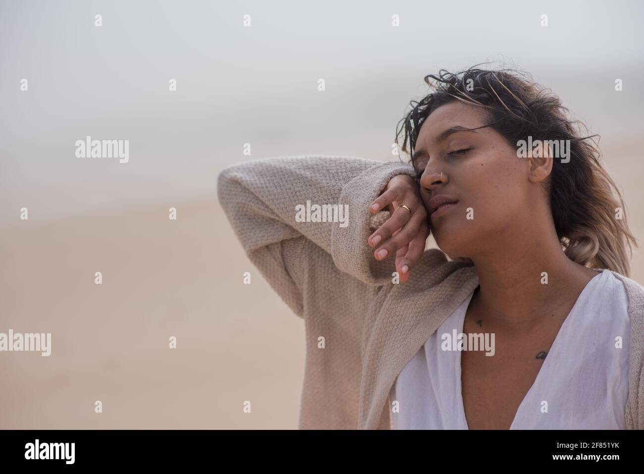 Woman touching her face while her eyes are closed Stock Photo - Alamy