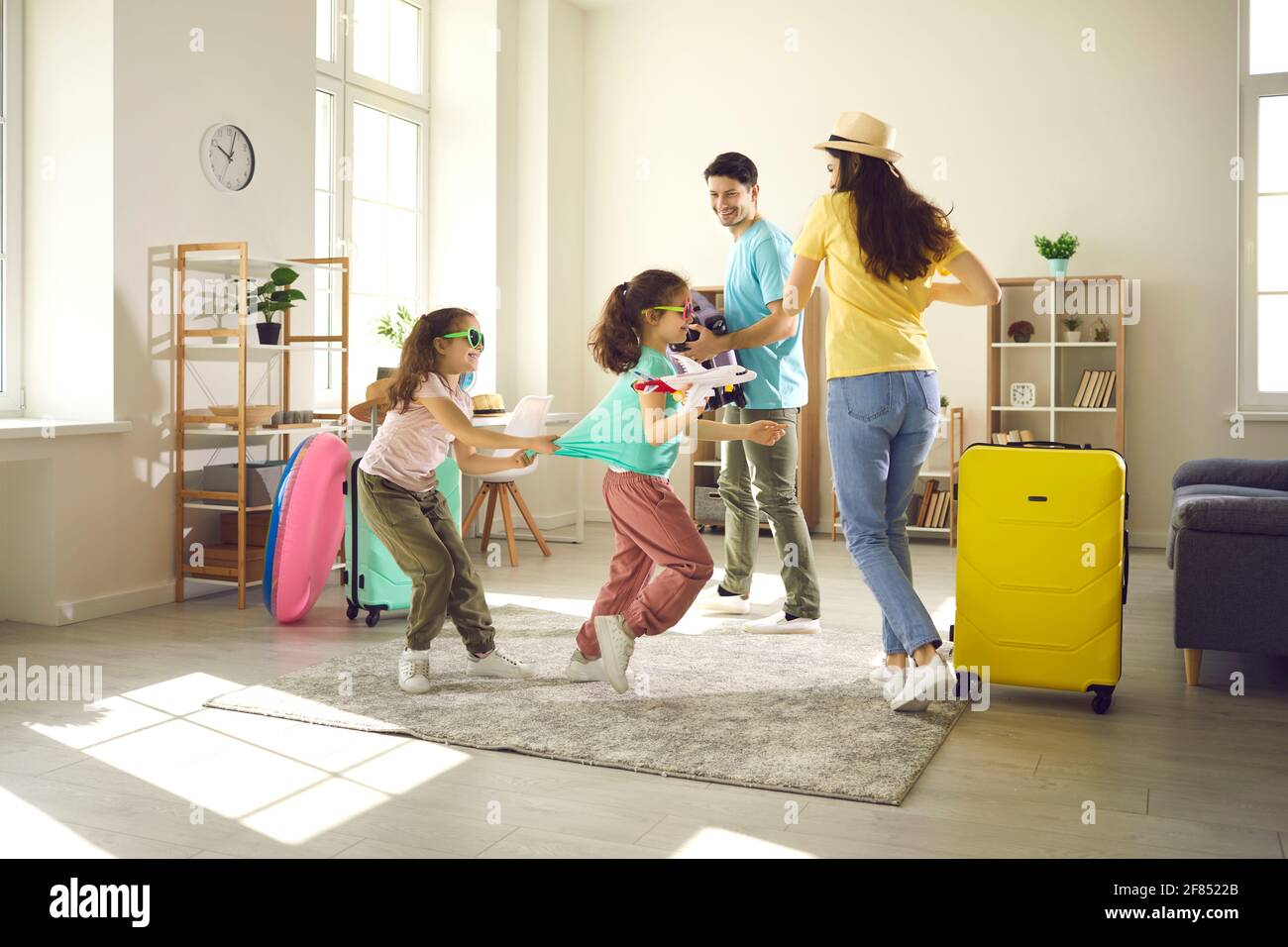 Happy children and mother having fun while getting ready for family holiday trip Stock Photo