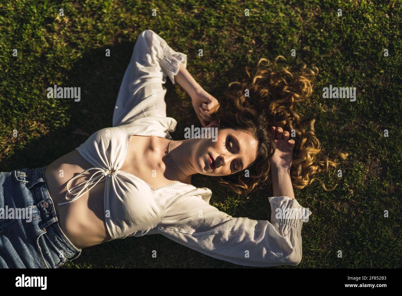 An overhead shot of a beautiful Spanish Caucasian woman wearing a top