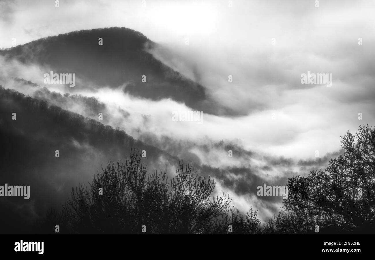 Abstract moodiness of clouds and fog swirling around the mountains and valleys of Shenandoah National Park in the winter. Stock Photo