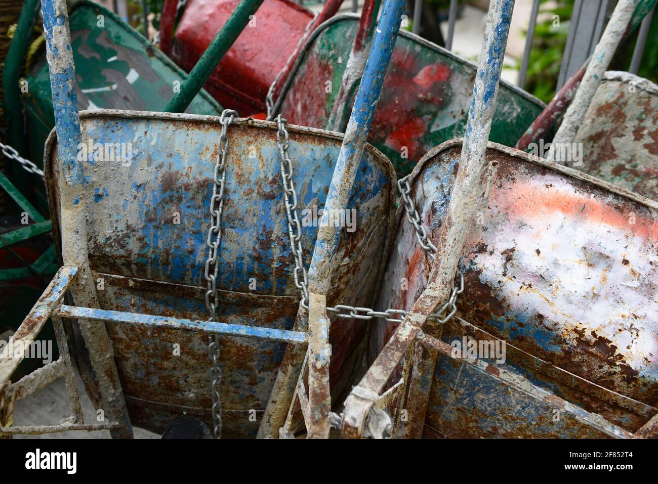 Cement encrusted wheelbarrows stored near a building site in Hong Kong, China Stock Photo