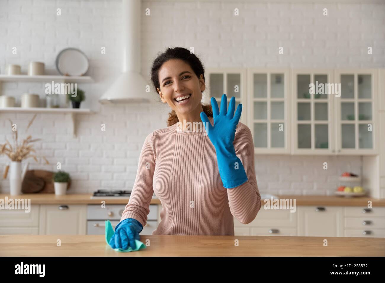 Portrait of smiling female vlogger advertizing new home cleaning products Stock Photo