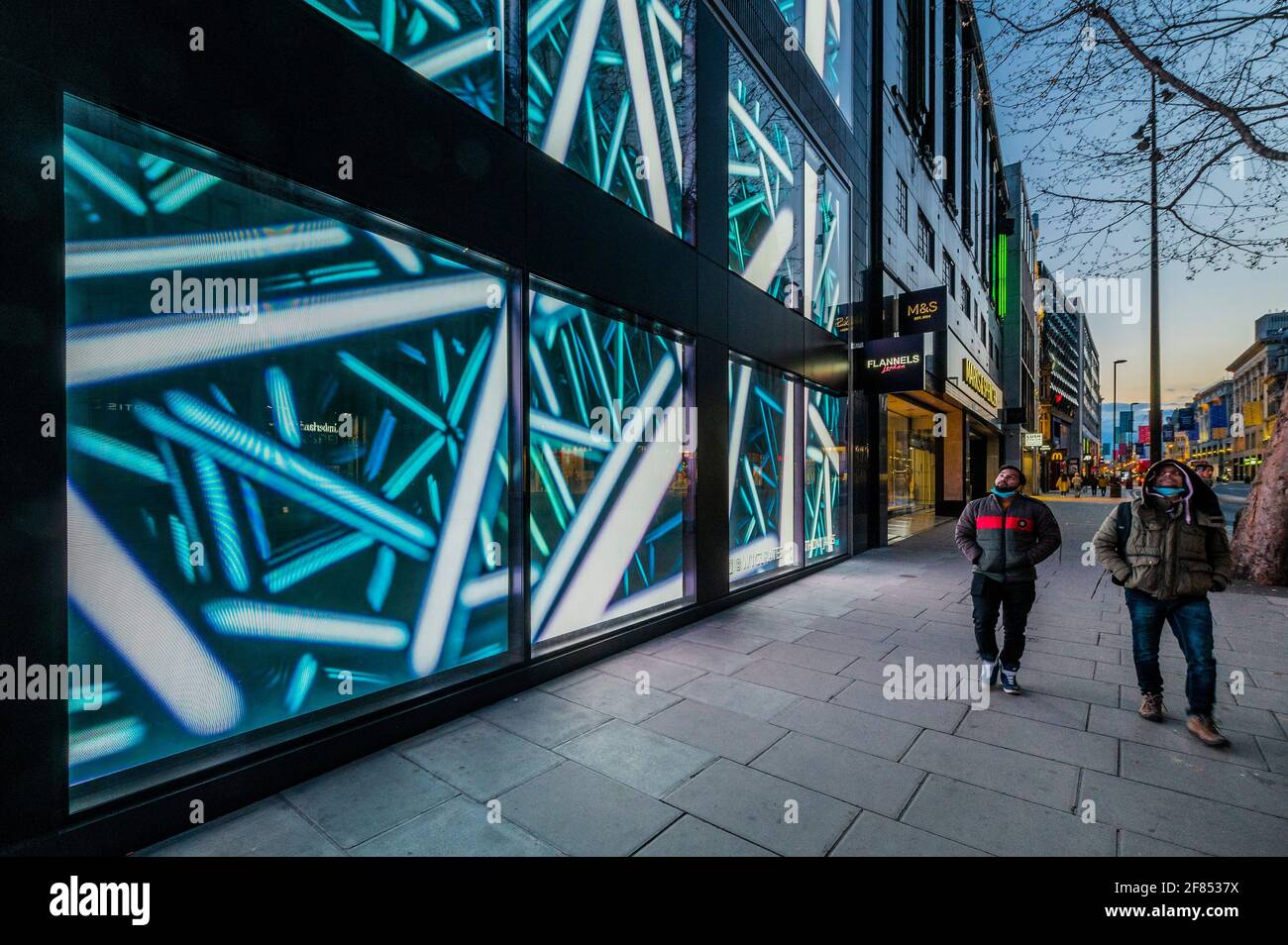 London, UK. 11th Apr, 2021. Constellations by light sculptor Anthony James presented by Opera Gallery and curated by W1 Curates. To celebrate non-essential retail opening in the UK, James' brand-new LED artwork Constellations will be installed on London's Oxford Street across 36 digital canvases over three stories, using 33 million LED lightbulbs. The innovative art installation uses state-of-the-art technology including an 8K resolution system and is part of the longest running permanent art installation in Europe. Credit: Guy Bell/Alamy Live News Stock Photo