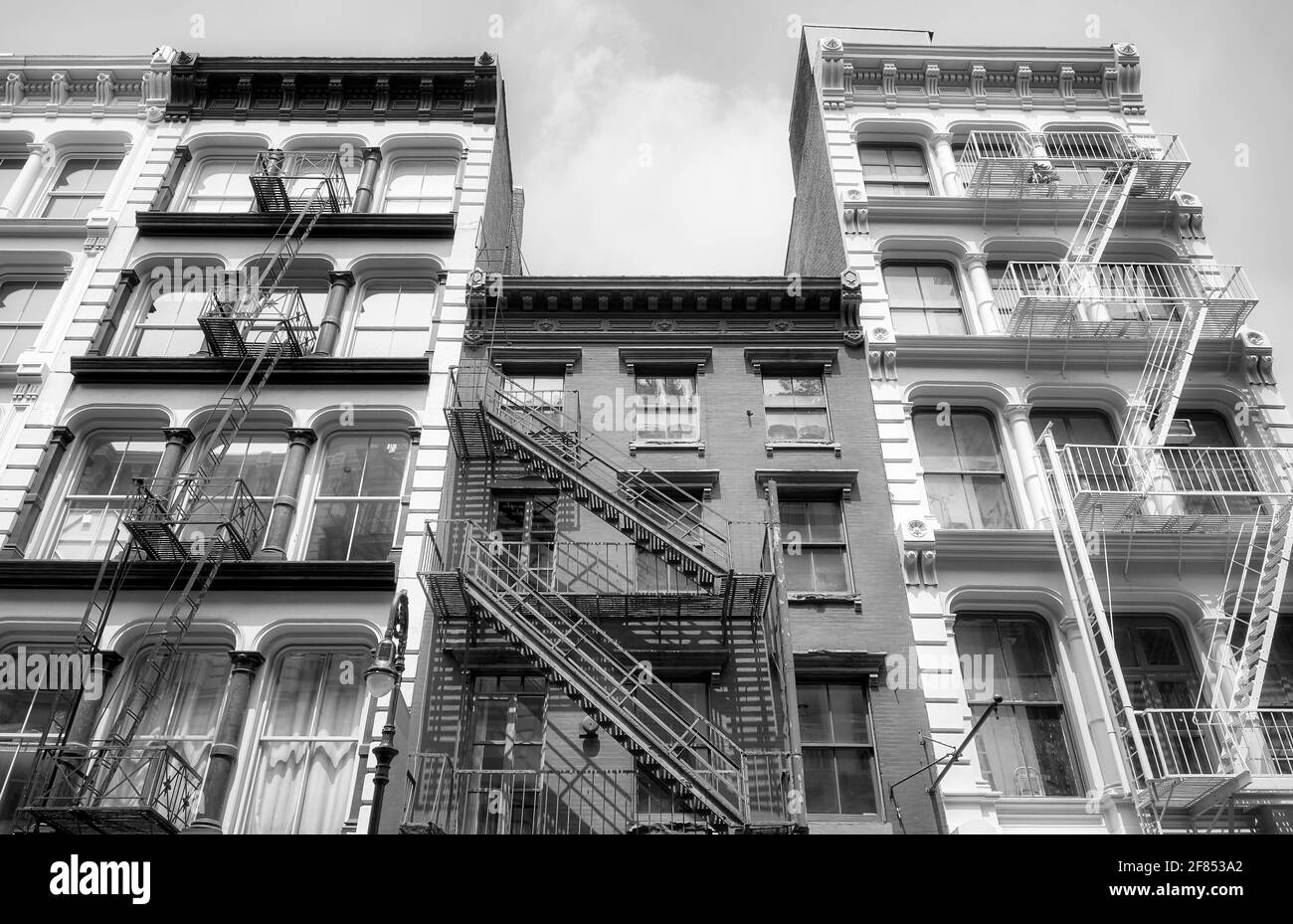 Black and white picture of old buildings with iron fire escapes, New York City, USA. Stock Photo