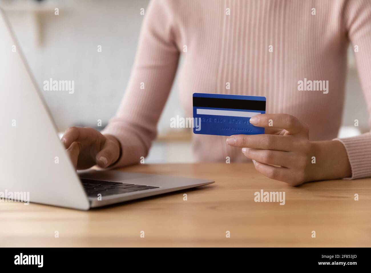 Young woman pay for goods at web store using card Stock Photo