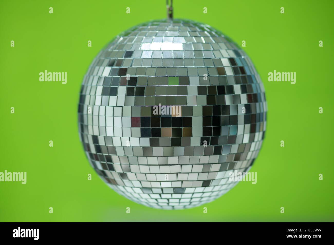 Shining Disco Ball dance music event equipment isolated on green background  Stock Photo - Alamy
