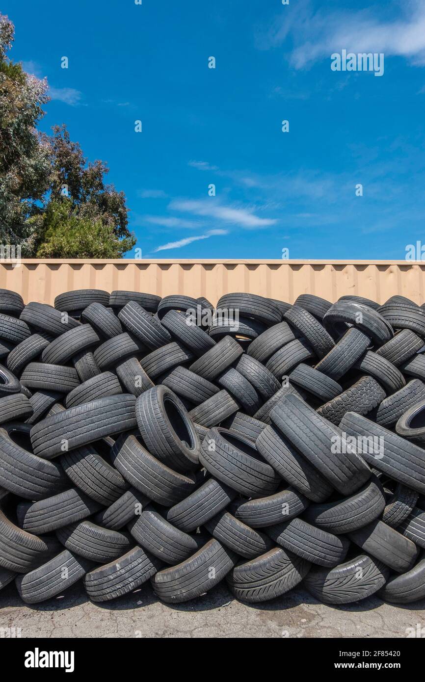 A lot of used tires stacked up outside a tire store Stock Photo Alamy