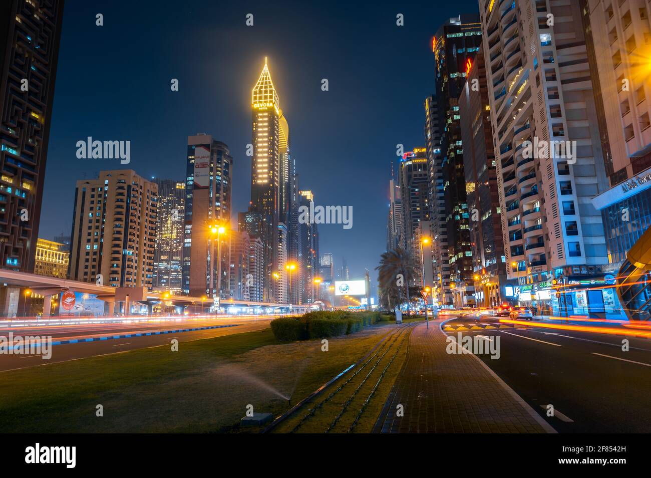 Dubai, United Arab Emirates - March 31, 2021: Downtown Dubai modern skyline above Sheikh Zayed road on of the busiest highways in the UAE at blue hour Stock Photo