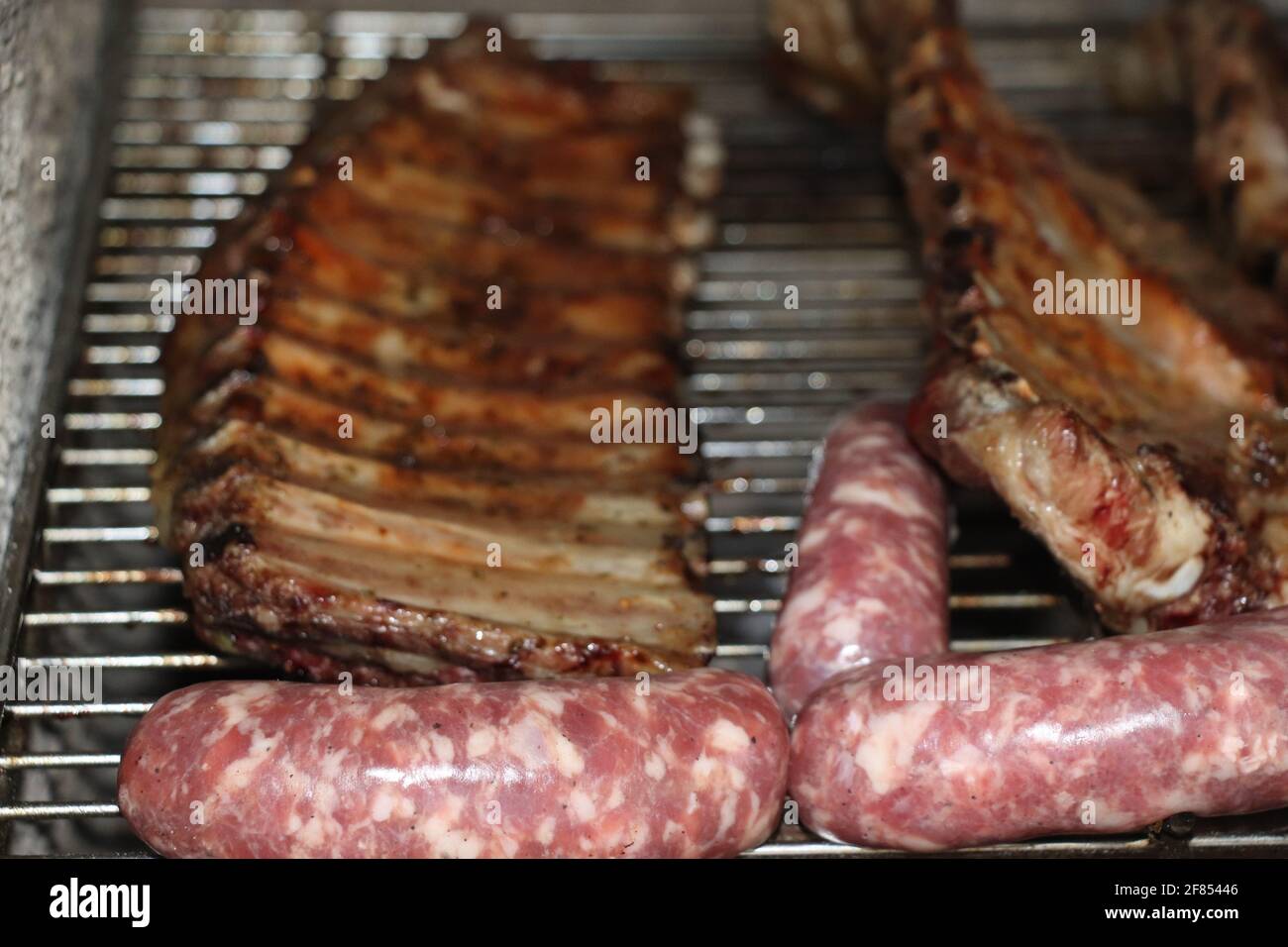 Mixed meat with ribs of beef and sausage on the grill Stock Photo