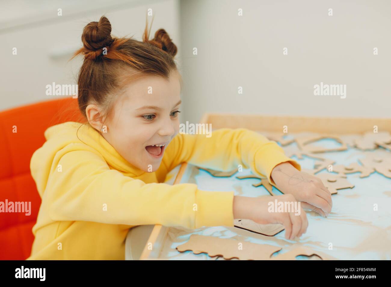 Baby girl playing with sand form toy. Early age education. Toddler cognitive psychology Stock Photo