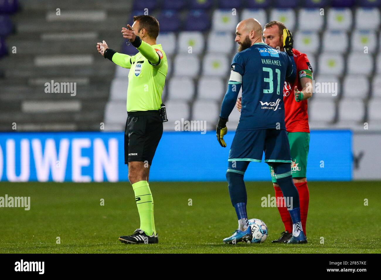 ANTWERPEN, BELGIUM - APRIL 11: Referee Nicolas Laforge, Mike Vanhamel of KFCO Beerschot-Wilrijk and Kevin Vandendriessche of KV Oostende during the Ju Stock Photo