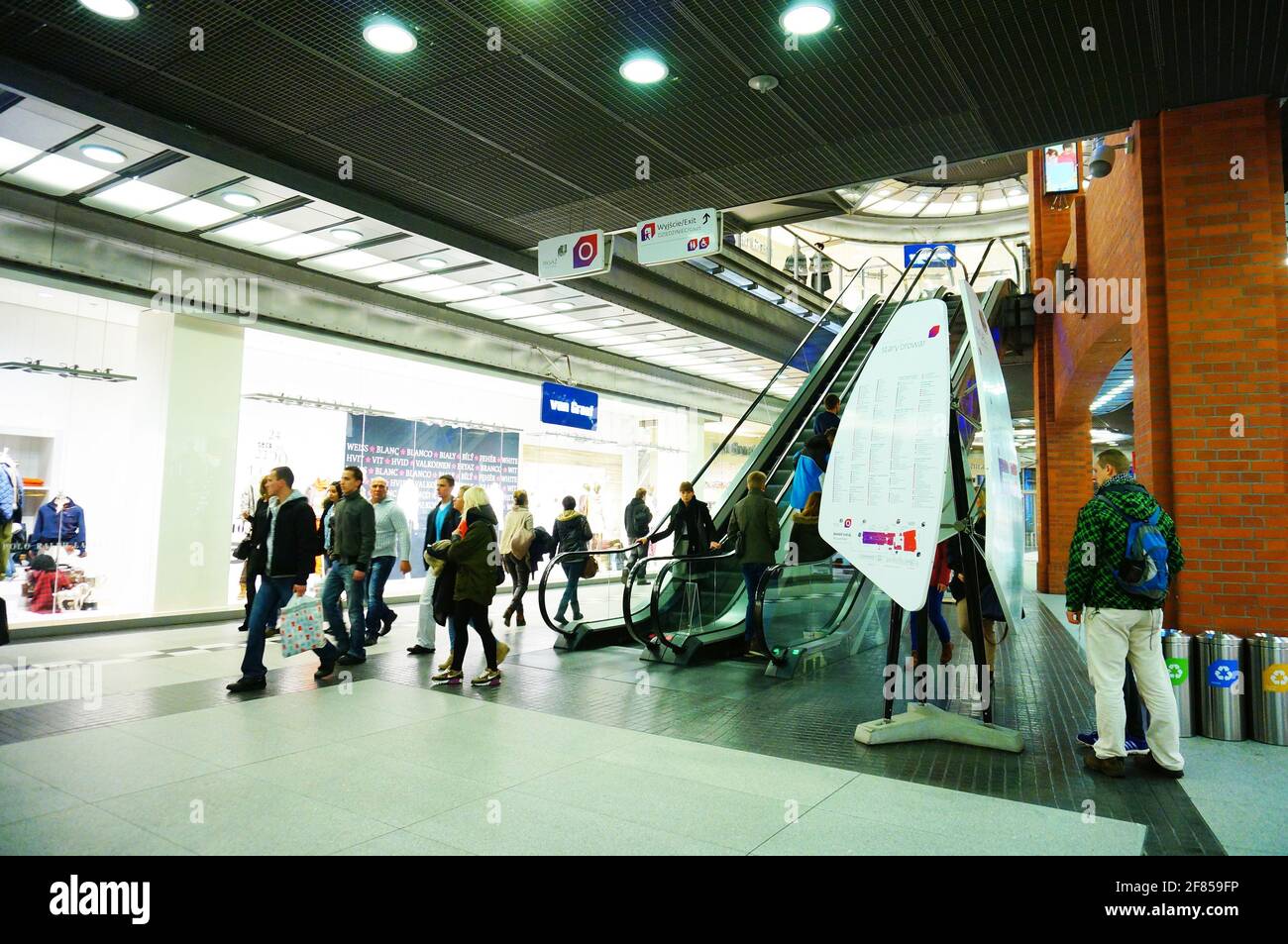POZNAN, POLAND - Feb 21, 2014: Walking people close by a escalator in the Stary Browar shopping mall Stock Photo