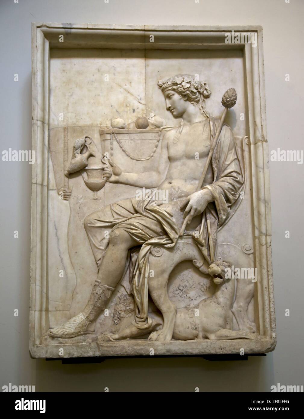 Marble relief with Dionysus seated. 1st century AD. Roman bas relief. Neo Attic style. Naples archaeology Museum. Naples, Italy. Stock Photo