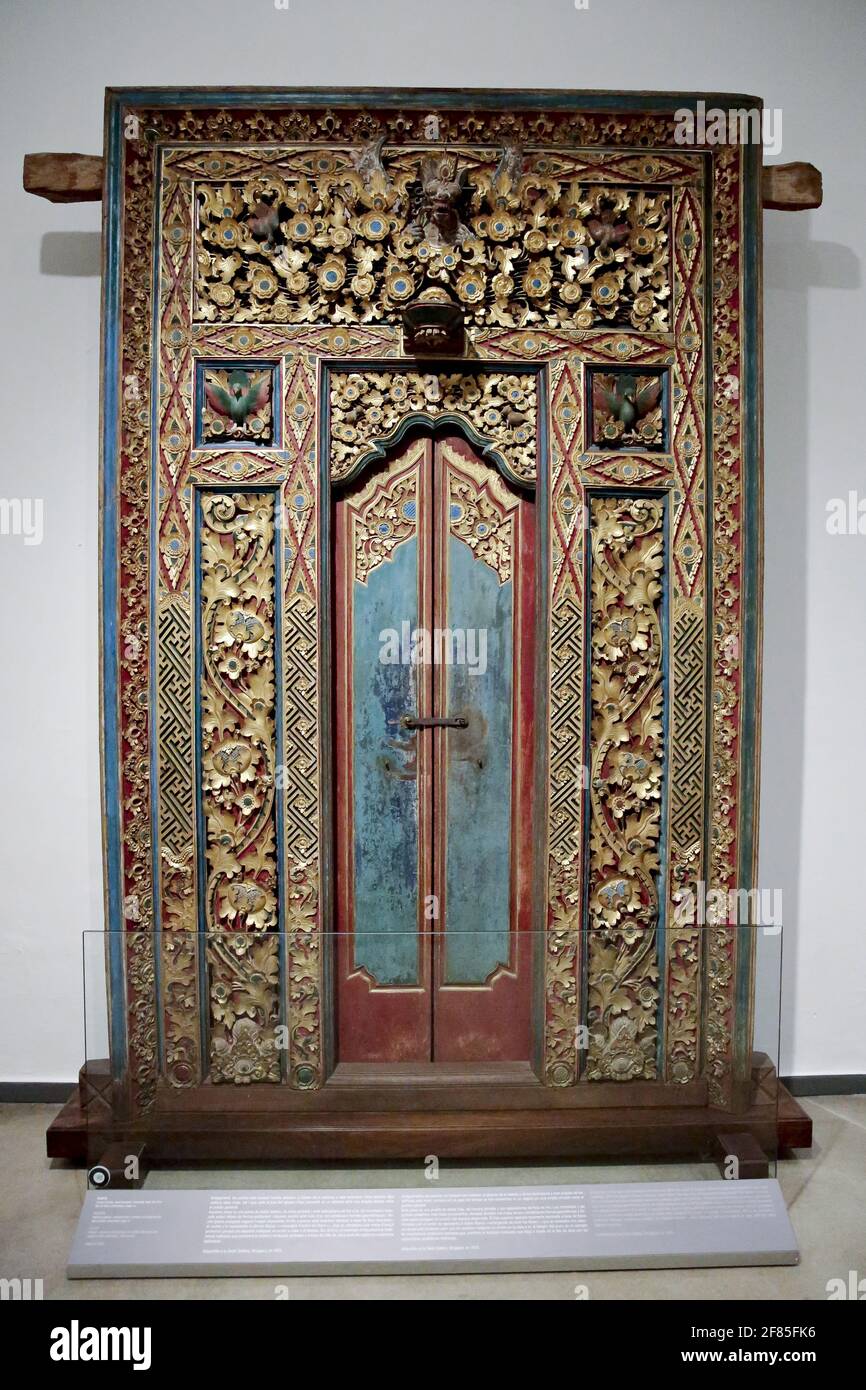 Carved wood door. 19th. century. Polichromed and gilded with gold leaf. Island of Bali, Indonesia. World Cultures Museum, Barcelona, Spain. Stock Photo