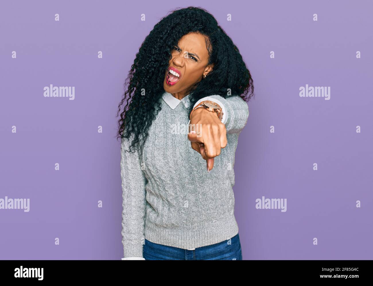Middle age african american woman wearing casual clothes pointing displeased and frustrated to the camera, angry and furious with you Stock Photo