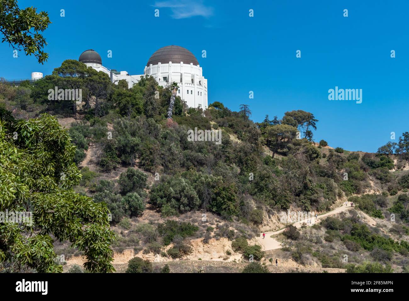 Hikers on trail behind Griffith Observatory on a beautiful sunny day in this Los Angeles open space, good for exercise with social distance. Stock Photo