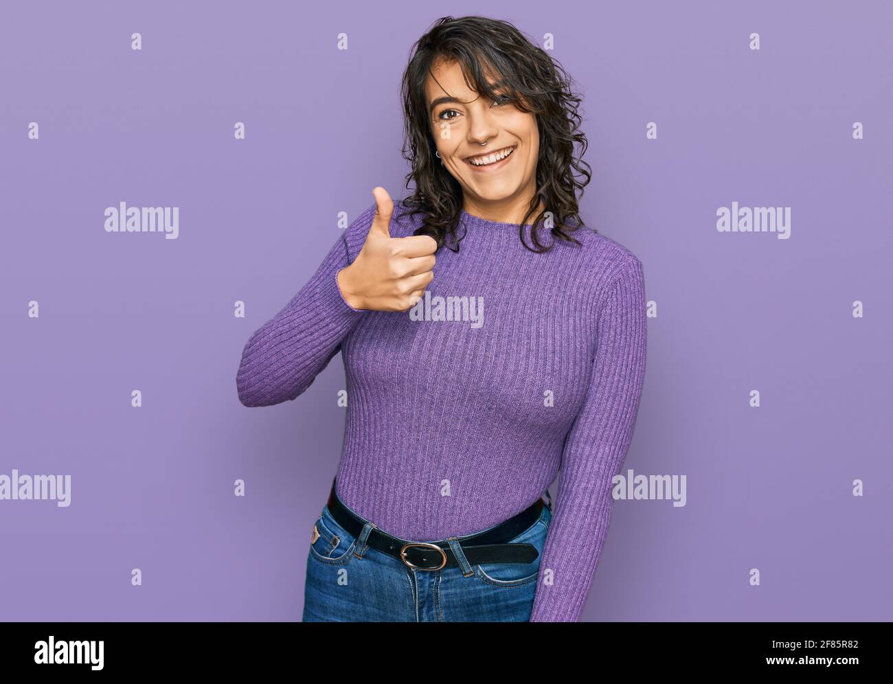 Young hispanic woman wearing casual clothes doing happy thumbs up ...