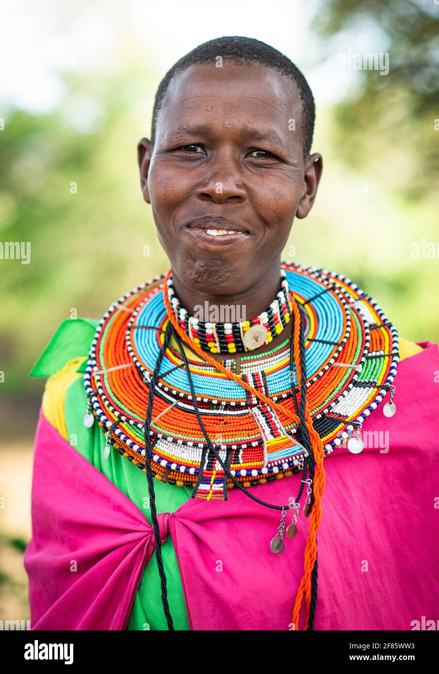 traditional African Maasai woman wearing beaded necklace and colorful shuka cloth Stock Photo