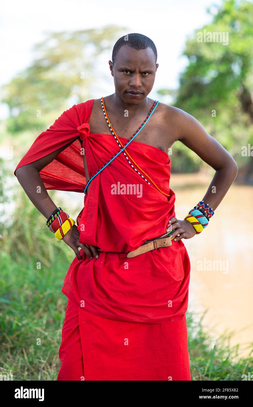 Male Maasai in traditional Shuka clothing with spear, Tsavo West
